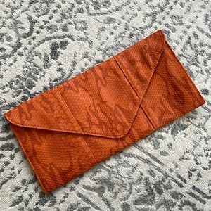 Snakeskin orange clutch